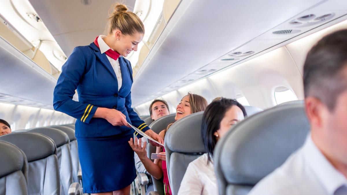 Flight attendant talks to people