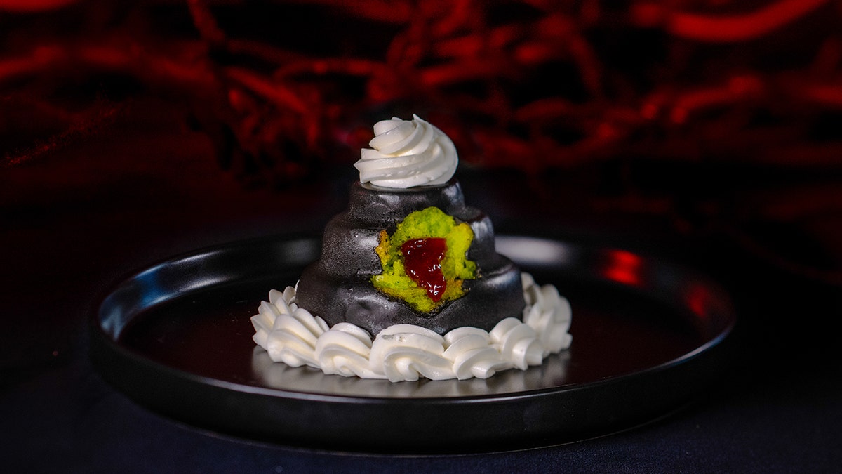 A charming mini wedding cake with green icing.