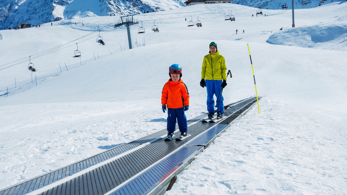 People on carpet ski lift