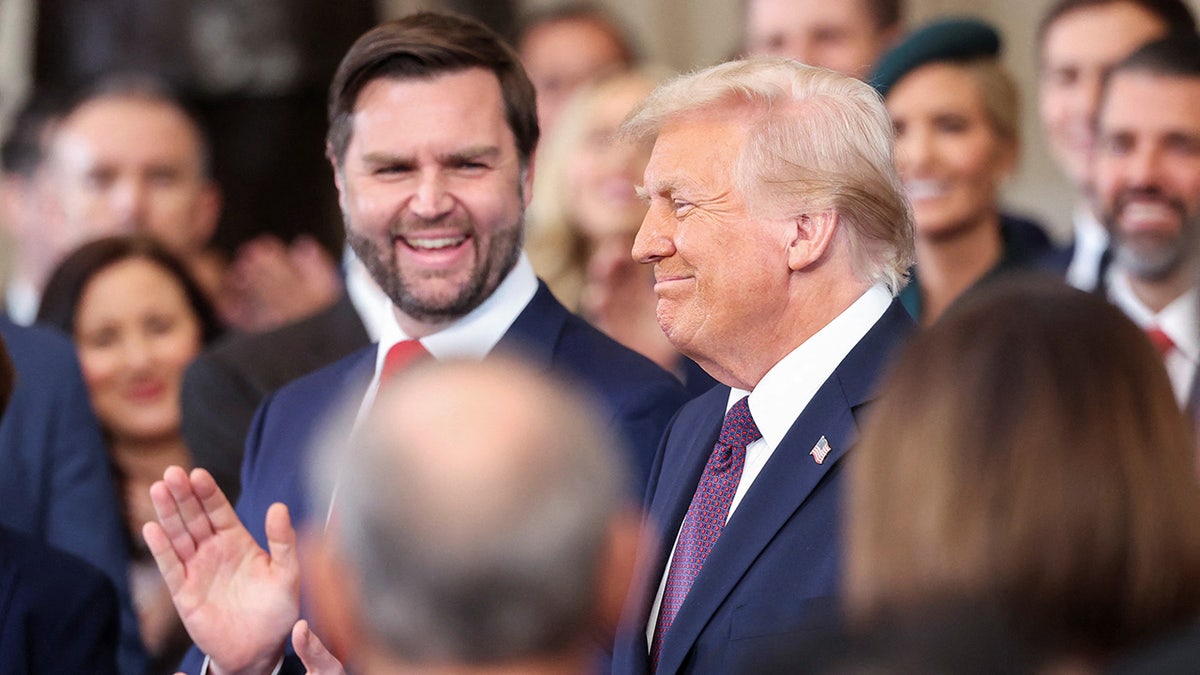 U.S. Vice President-elect J.D. Vance applauds as U.S. President-elect Donald Trump reacts