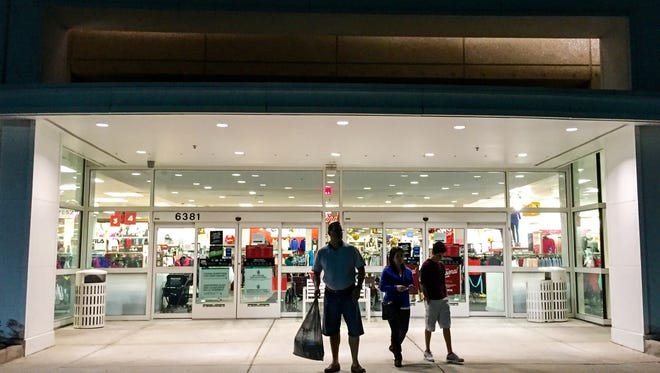 Black Friday shoppers trickle in and out of the Kohl's on Naples Boulevard before dawn on Friday, Nov 27, 2015, in North Naples.